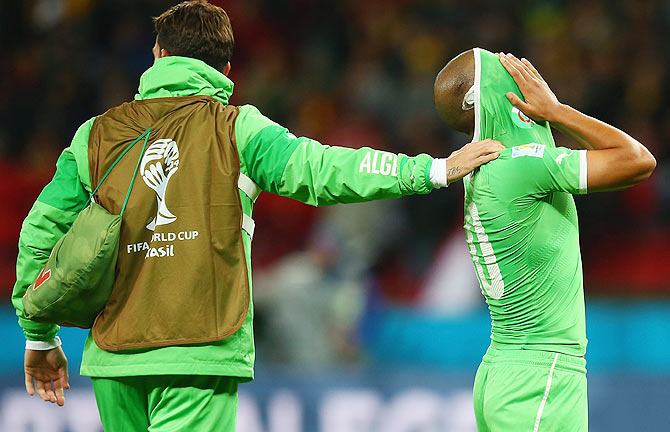 Sofiane Feghouli of Algeria (right) reacts after their defeat by Germany 2-1 during the 2014 FIFA World Cup Brazil Round of 16 match on Monday