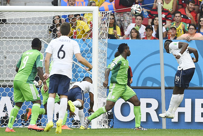 France's Paul Pogba heads the ball to score a goal against Nigeria during their 2014 World Cup round of 16 game at the Brasilia national stadium in Brasilia on Monday