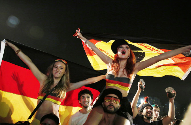 German soccer fans celebrate at the end of the match against Algeria during a broadcast at Copacabana beach in Rio de Janeiro