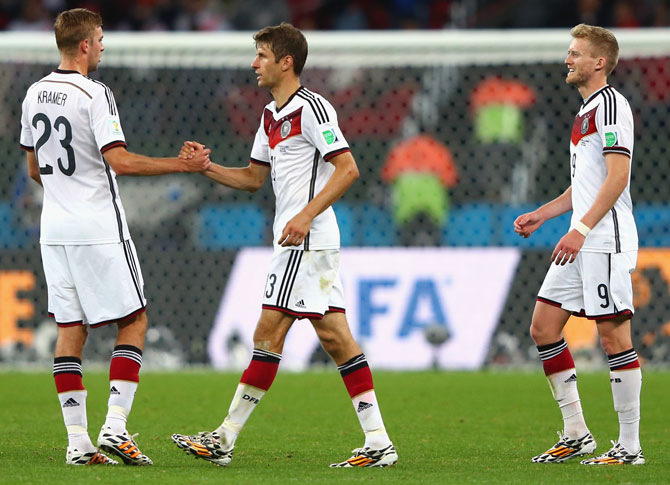(left to right) Christoph Kramer, Thomas Mueller, Andre Schuerrle of Germany celebrate after defeating Algeria 2-1
