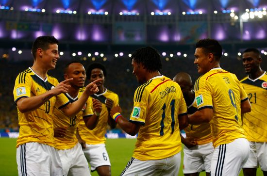 James Rodriguez of Colombia, left, celebrates after scoring