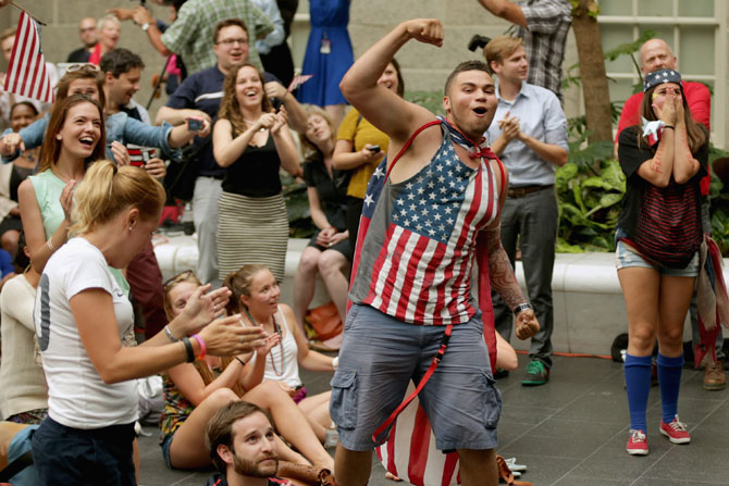 Fans react after watching the U.S. score it's only goal in a World Cup loss to Belgium