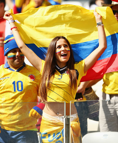 A Colombia fan cheers during the World Cup match against Japan in Cuiaba