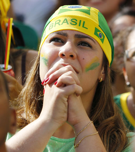 A Brazil fan reacts at a fan zone in Recife