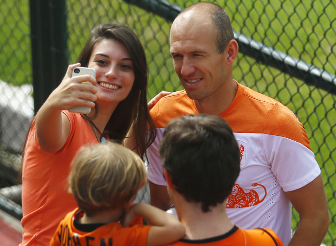 Netherlands' player Arjen Robben poses for a photo with a fan after a training session in Rio de Janeiro