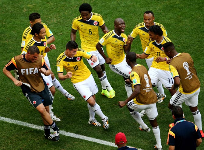 James Rodriguez (No 10) of Colombia celebrates by dancing with teammates