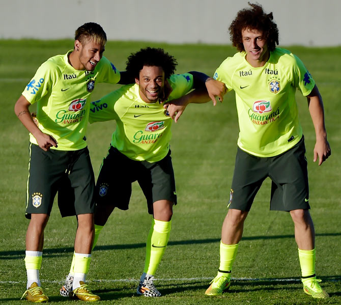Neymar (left), Marcelo (centre) and David Luiz link up to defend the ball during a training session at the President Vargas stadium in Fortaleza on Thursday, the eve of their quarter-final match against Colombia
