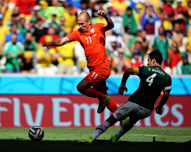 Arjen Robben of the Netherlands tries to get the ball past Mexico's Rafael Marquez
