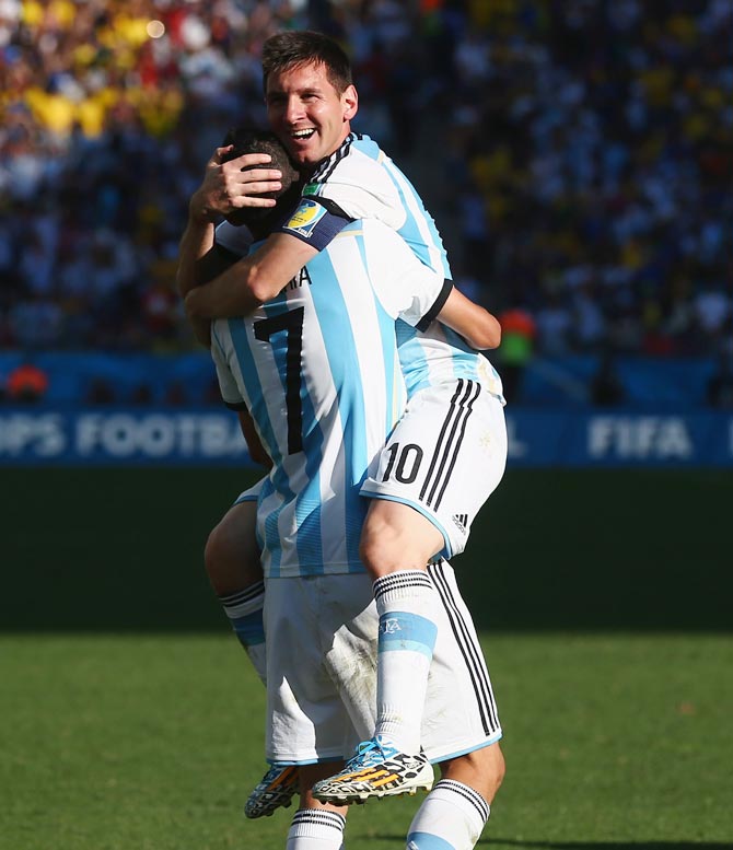 Angel di Maria of Argentina (left) celebrates with Lionel Messi after scoring the winner in extra time against Switzerland