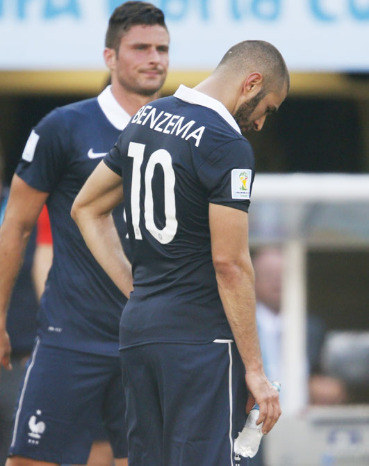 France's Karim Benzema (front) reacts beside teammate Olivier   Giroud to their loss after their 2014 World Cup quarter-finals against Germany at the Maracana stadium in Rio de Janeiro