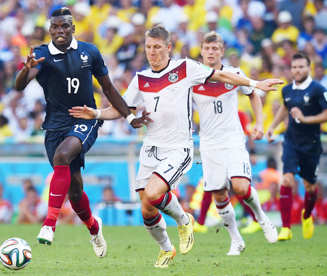 Paul Pogba of France and Bastian Schweinsteiger of Germany compete for the ball