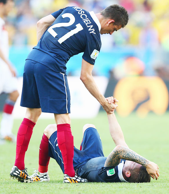 France's Laurent Koscielny (left) consoles teammate Mathieu Debuchy after being defeated by Germany