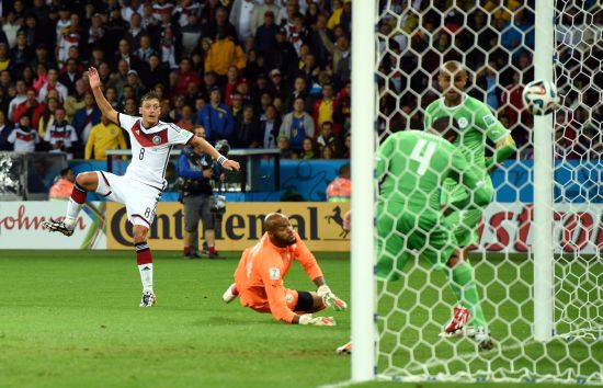 Mesut Oezil of Germany scores his team's second goal past Rais M'Bolhi of Algeria