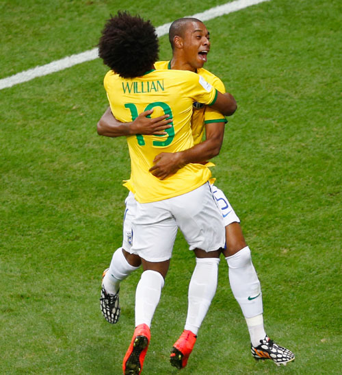 Fernandinho of Brazil (right) celebrates scoring his team's fourth goal with Willian against Cameroon
