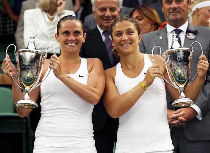 Roberta Vinci (left) and Sara Errani of Italy celebrate with the winners trophy