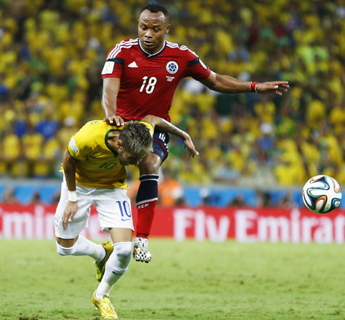 Brazil's Neymar (bottom) is fouled by Colombia's Camilo Zuniga during their quarter-final in Fortaleza