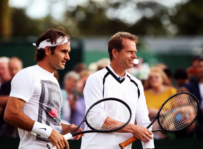 Roger Federer (left) speaks to his coach Stefan Edberg