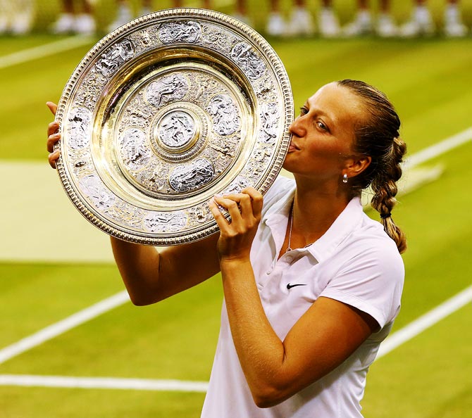 Petra Kvitova of Czech Republic poses with the Venus Rosewater Dish trophy after winning the Wimbledon title