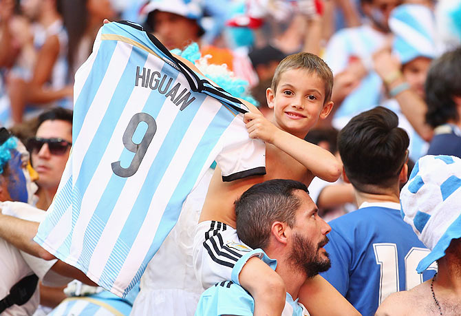 An Argentina fan holds up a Gonzalo Higuain shirt