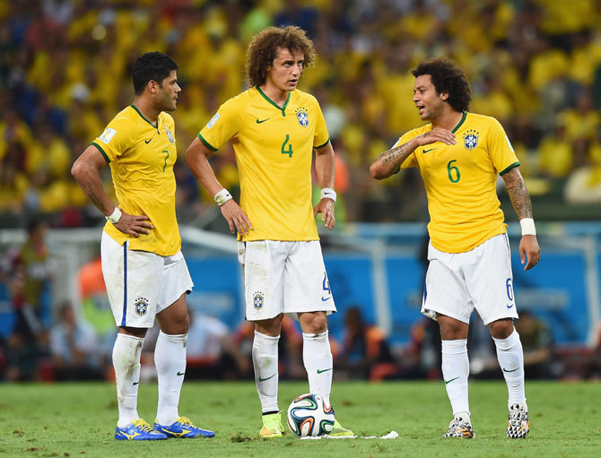 Hulk, David Luiz and Marcelo of Brazil prepare to take a free kick during the match against Colombia at Castelao