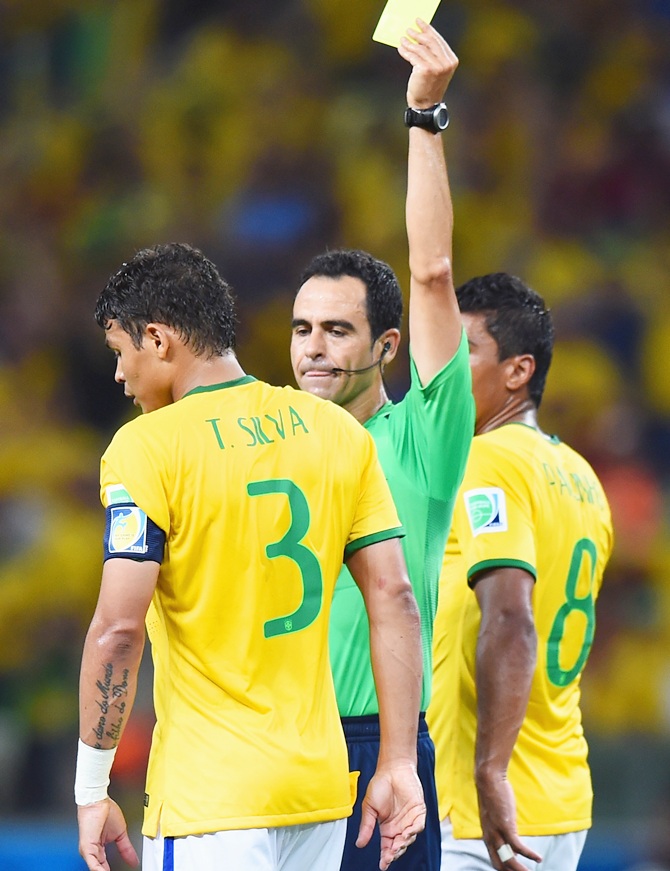 Thiago Silva of Brazil is shown a yellow card by referee Carlos Velasco Carballo   during the 2014 FIFA World Cup Brazil Quarter Final match between Brazil and Colombia at Castelao