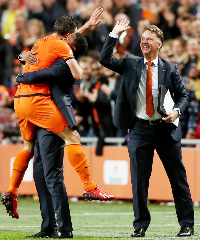 Robin van Persie of Holland celebrates with Patrick Kluivert and manager Luis van Gaal
