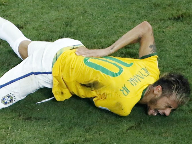 Brazil's Neymar grimaces in pain after a challenge by Colombia's Camilo Zuniga during their quarter-final at the Castelao arena in Fortaleza