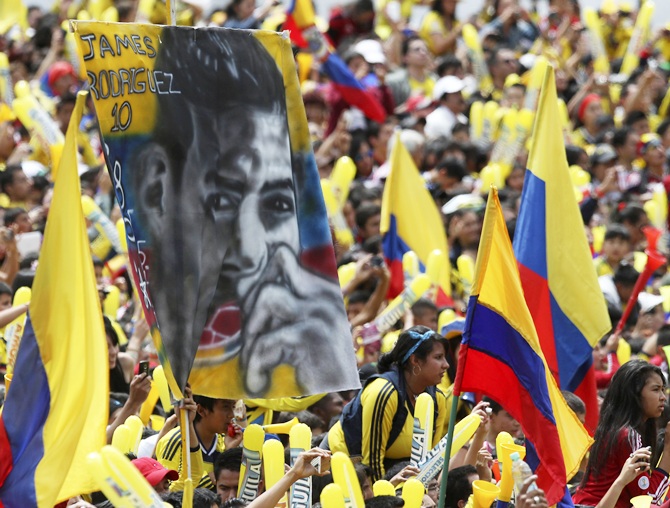 A Colombian fan holds a banner of James Rodriguez while waiting with other fans   for the arrival of Colombia's national soccer team at Bolivar park in Bogota