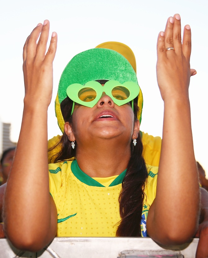 A Brazil fan prays