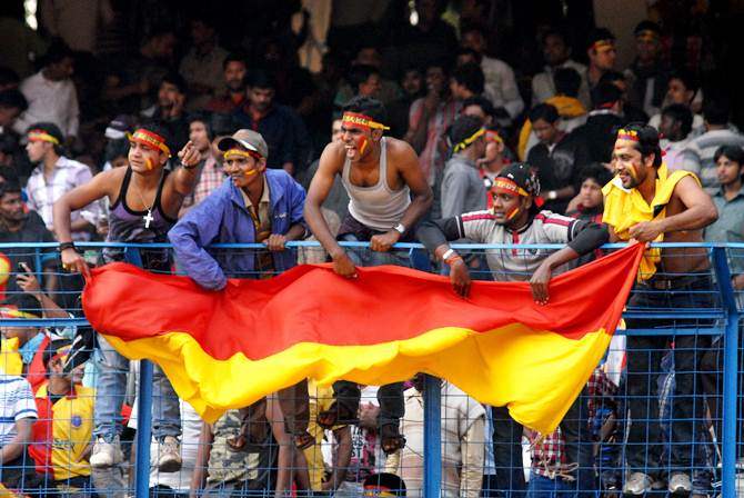 East Bengal fans wave the team flag