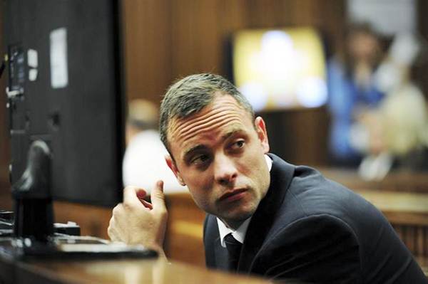 Oscar Pistorius sits in the dock during court proceedings