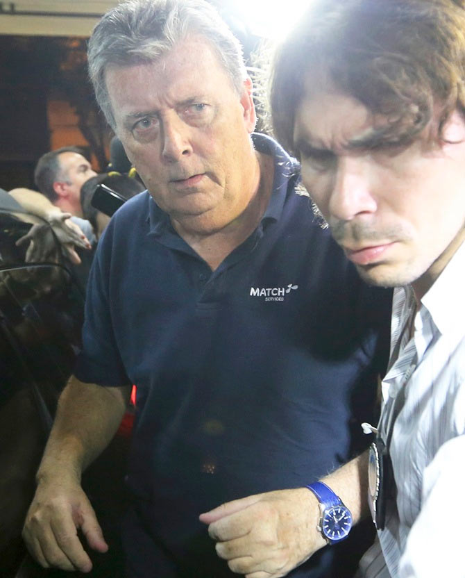 Ray Whelan, left, of Switzerland-based Match Services, arrives at a police station after being arrested in Rio de Janeiro on Monday