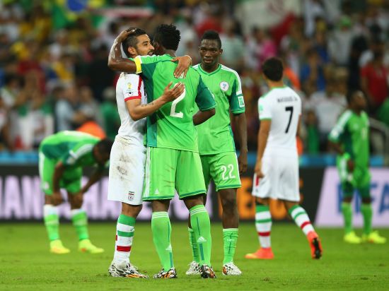 Reza Ghoochannejhad of Iran reacts with Joseph Yobo of Nigeria after their draw