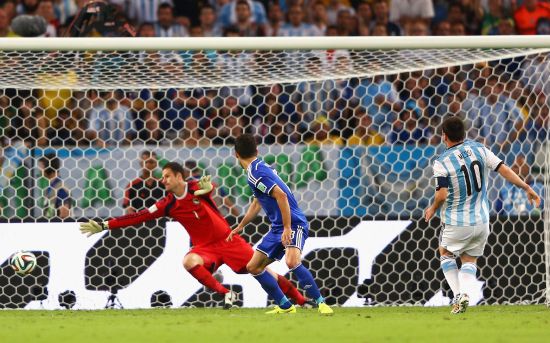 Lionel Messi scores Argentina's second goal past Asmir Begovic of Bosnia and Herzegovina