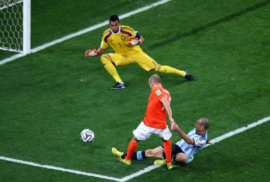 Javier Mascherano of Argentina tackles Arjen Robben of the Netherlands