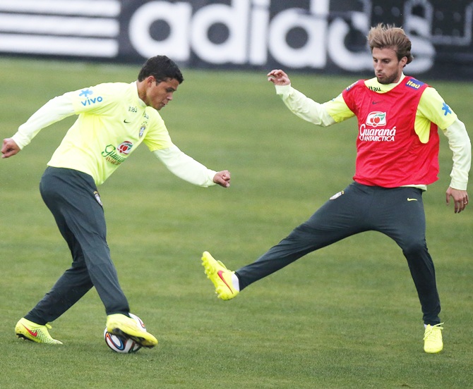 Brazil's national soccer team players Thiago Silva, left, and Henrique attend a training session in Teresopolis, near Rio de Janeiro