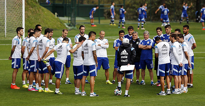 Argentina's team coach Alejandro Sabella (centre black jacket) talks to players during a training session  on Thursday
