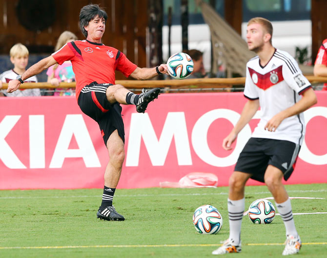 Joachim Loew, head coach of Germany (left) controls the ball during the German national team training session at Campo Bahia on