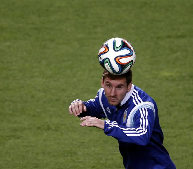 Argentina's Lionel Messi heads the ball during a training session