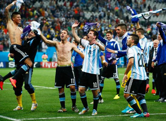 Lionel Messi of Argentina celebrates with teammates after defeating the Netherlands