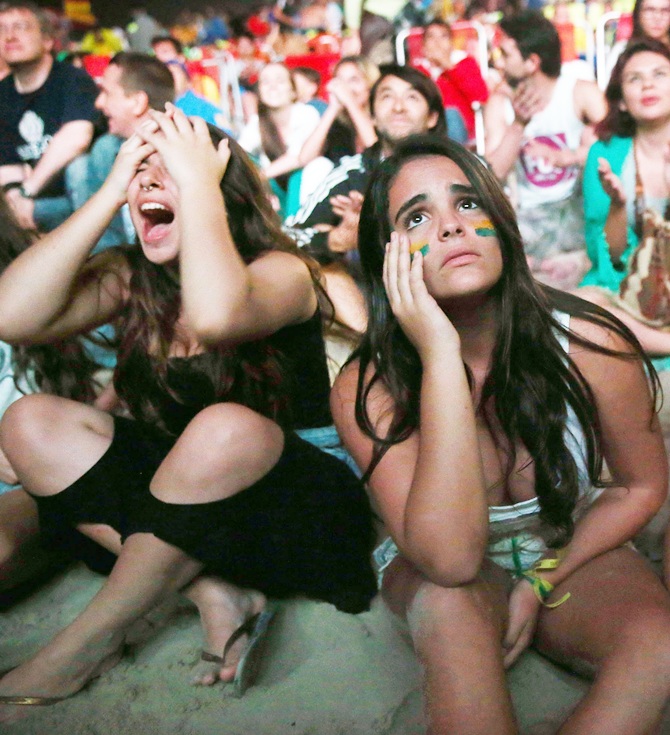 Brazil fans react after the Netherlands scored to take a 3-0 lead in extra time on Copacabana Beach