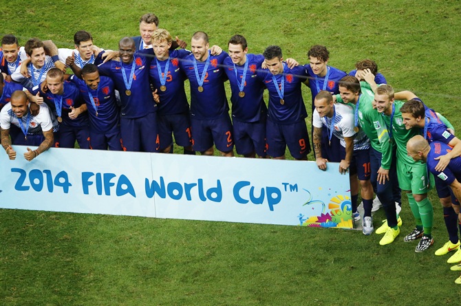 Netherlands team pose after winning the 2014 World Cup   third-place playoff against Brazil at the Brasilia national stadium