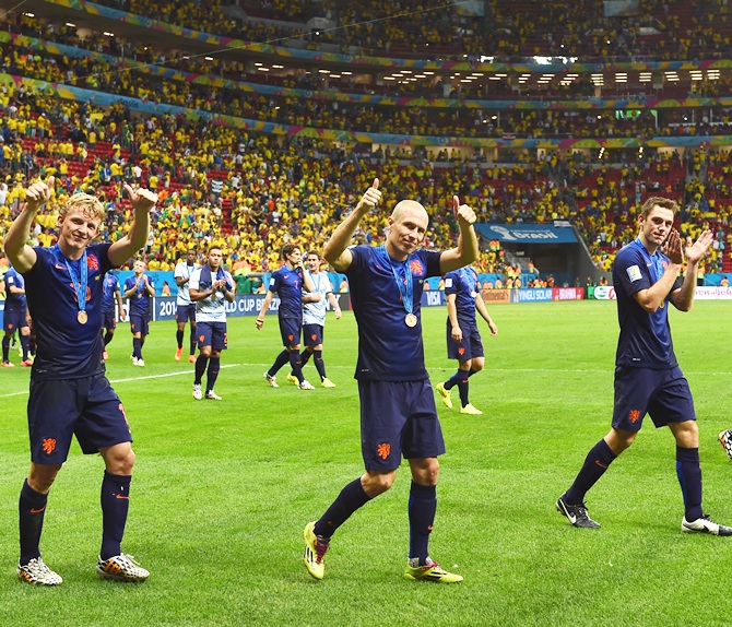 From Left, Dirk Kuyt, Arjen Robben and Stefan de Vrij of the Netherlands acknowledge the fans after defeating Brazil 3-0