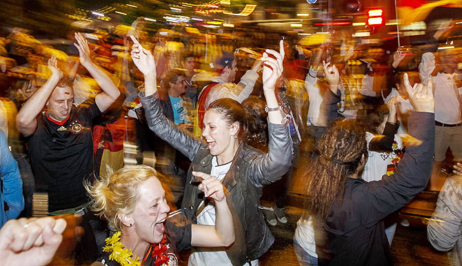 German fans celebrate at the 'Reeperbahn' red light district in Hamburg after Germany won the World Cup final against Argentina on Sunday