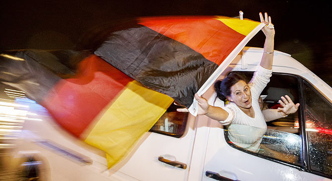 German fans celebrate as they drive along the 'Reeperbahn' red light district in Hamburg after Germany won the World Cup final against Argentina on Sunday