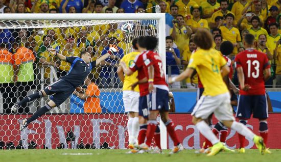 Brazil's David Luiz (No 4) scores from his free-kick past Colombia goalkeeper David Ospina