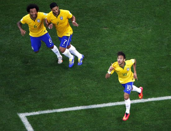 Brazil's Neymar, right, celebrates with teammates Marcelo, left, and Hulk after scoring