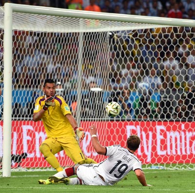 Mario Goetze of Germany slips the ball past Argentina goalkeeper Sergio Romero in the World Cup final on Sunday.