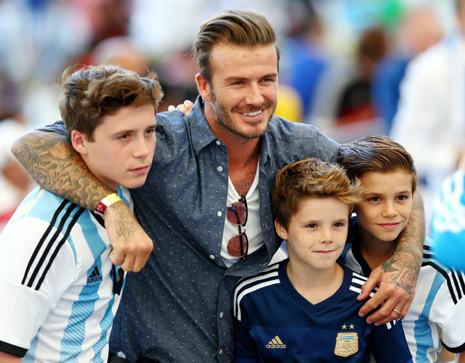 Former England international David Beckham and sons Brooklyn Beckham (left), Cruz Beckham (2nd from right) and Romeo Beckham (right) prior to the World Cup final between Germany and Argentina at Maracana in Rio de Janeiro on Sunday