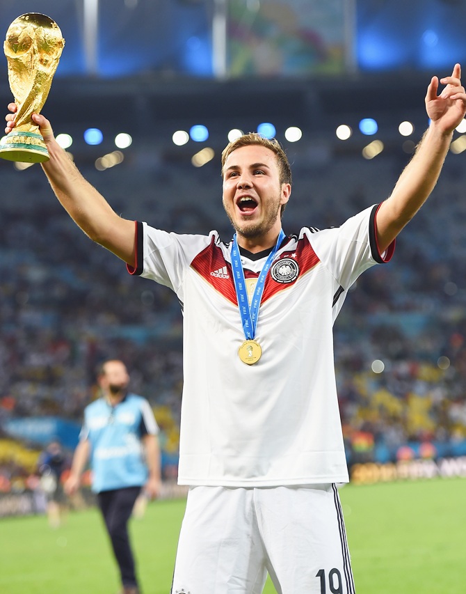 Mario Goetze of Germany celebrates with the World Cup trophy